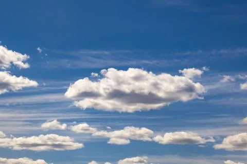 Blue sky background with big tiny stratus cirrus striped cloud before storm. Stock Photos