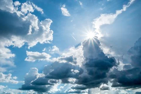 Blue sky background with clouds and sun. Stock Photos