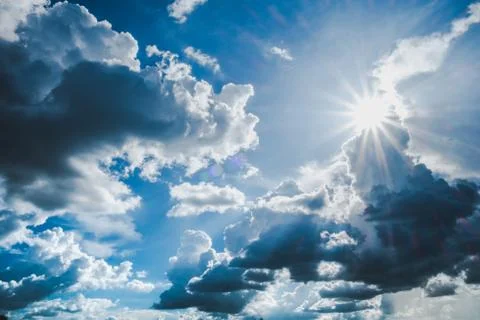 Blue sky background with clouds and sun. Stock Photos