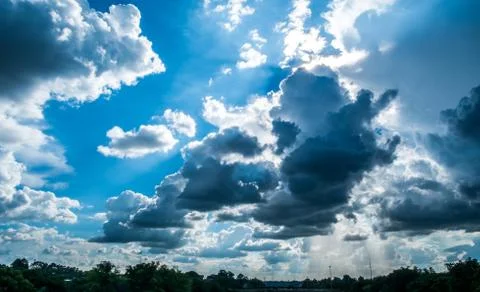 Blue sky background with clouds and sun. Stock Photos