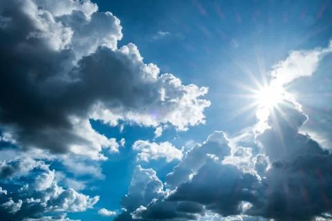 Blue sky background with clouds and sun. Stock Photos