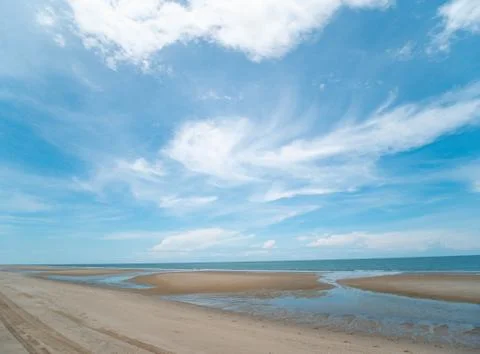 Blue sky background with clouds, background sky and Sea, sand beach Stock Photos