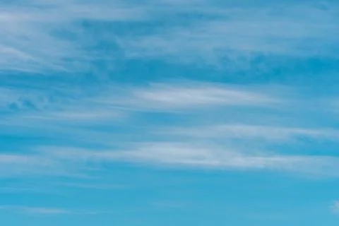 Blue sky background with clouds. Nature backdrop. Stock Photos