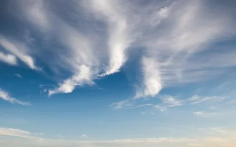 Blue sky background with clouds Фото