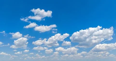 Blue sky background with clouds. Summer sky white clouds. Bright sky fluffy.. Stock Photos