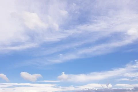 Blue sky background with clouds in sunlight Stock Photos