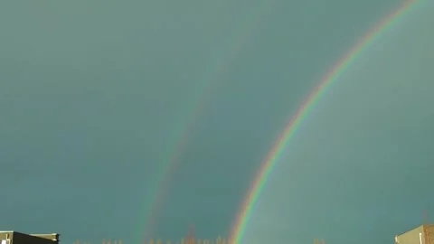 Blue sky background with double rainbow Stock Footage 316396783