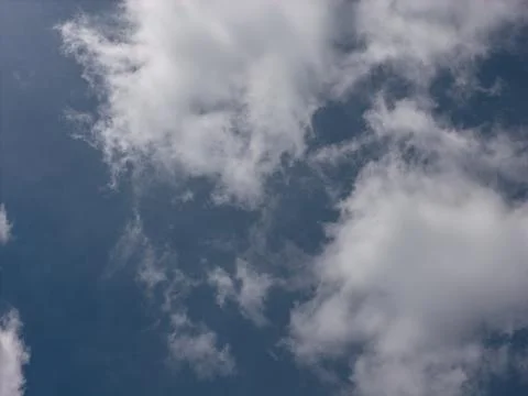 Blue sky background with small white clouds Фото