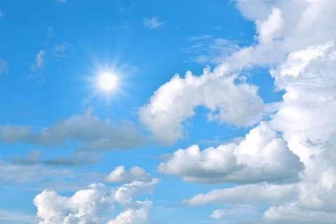 Blue sky background with tiny clouds and sun Stock Photos