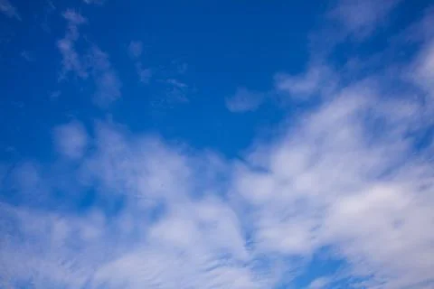 Blue sky background with tiny clouds Stock Photos