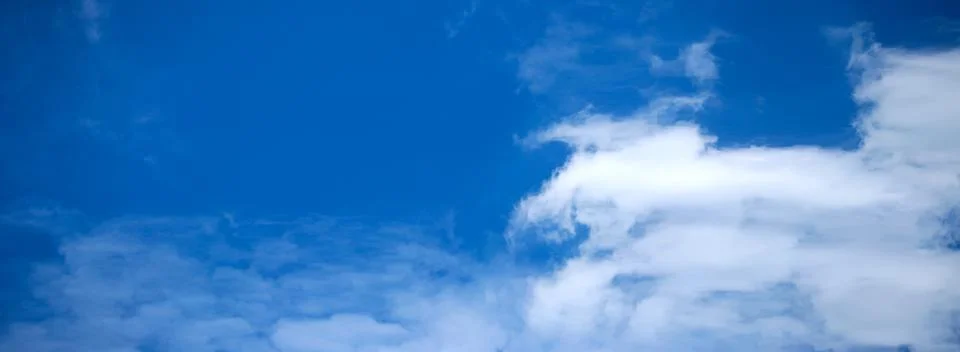 Blue Sky Background with tiny Clouds. Panorama Stock Photos