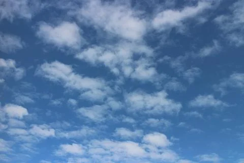 Blue sky background with tiny clouds Stock Photos