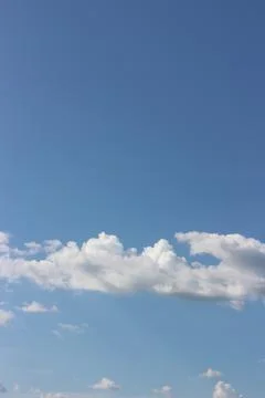 Blue sky background with tiny clouds Foto stock