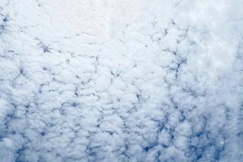 Blue sky background with tiny clouds. Nature background. Sky texture. Stock Photos