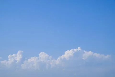 Blue sky background with tiny fluffy clouds. With copy space for text 写真素材