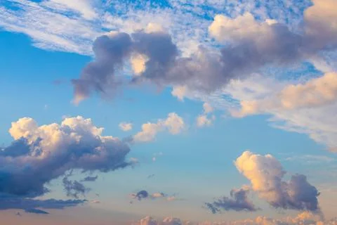 Blue sky background with tiny sunset clouds  in summer season. Cloud texture Stock Photos