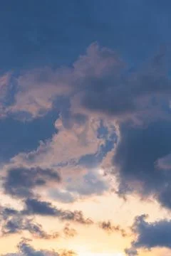 Blue sky background with tiny sunset clouds  in summer season. Cloud texture Stock Photos