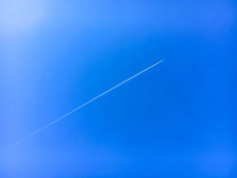 Blue sky background. trail of a plane in a blue sky concept Stock Photos