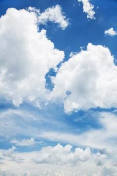 Blue sky background with white clouds in summertime. Stock Photos