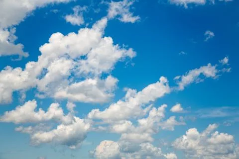 Blue sky background with white clouds in summertime. Stock Photos