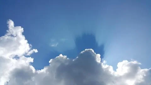 Blue sky background with white clouds and sun ray Stock Photos