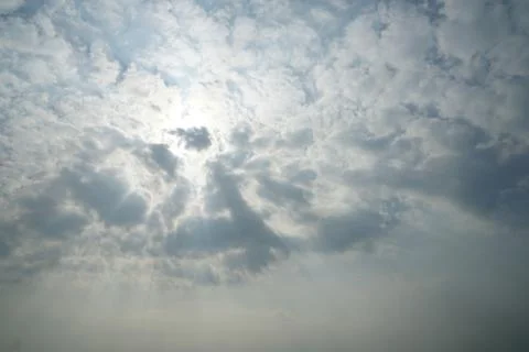 Blue sky background with white clouds and sun ray Stock Photos