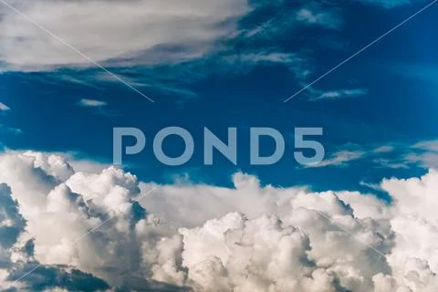 Blue sky background with white clouds. Cumulus clouds. Stock Photos