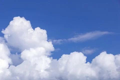 Blue sky background with white clouds, rain clouds on sunny day. Stockfoto's
