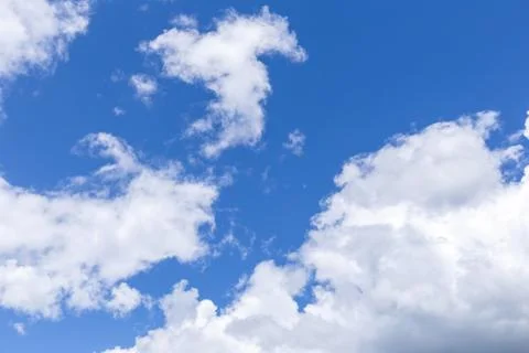 Blue sky background with white clouds, rain clouds on sunny day. Stock Photos