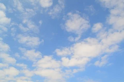Blue sky background with white clouds. Holiday atmosphere. Sky texture or wal Stock Photos