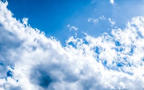 Blue sky background, white clouds and bright sunlight Stock-Fotos