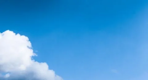 Blue sky background, white clouds and bright sunlight Stock Photos