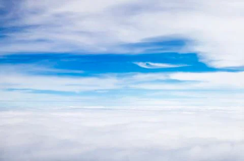 Blue sky background with white clouds on airPlane window view Stock Photos