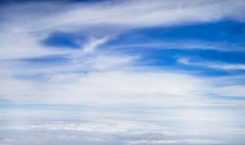 Blue sky background with white clouds on airPlane window view Stock Photos