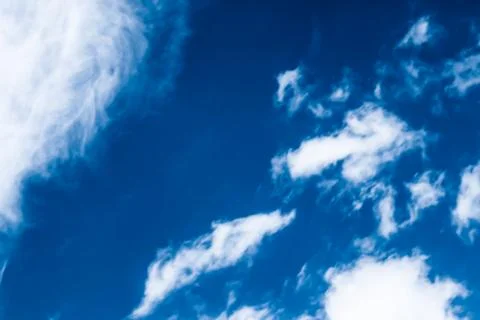 Blue sky background, white clouds and bright sunlight Stock Photos