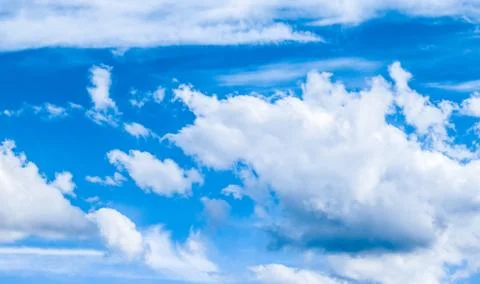 Blue sky background, white clouds and bright sunlight Stock Photos