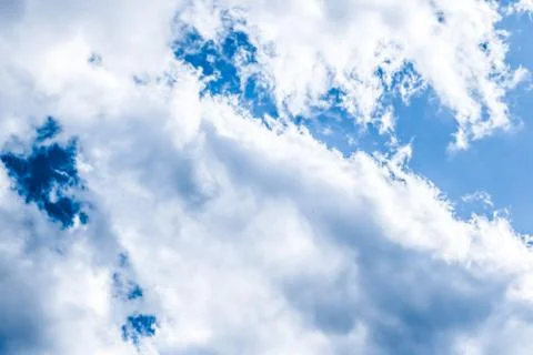 Blue sky background, white clouds and bright sunlight Stock Photos