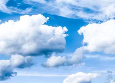 Blue sky background, white clouds and bright sunlight Stock Photos