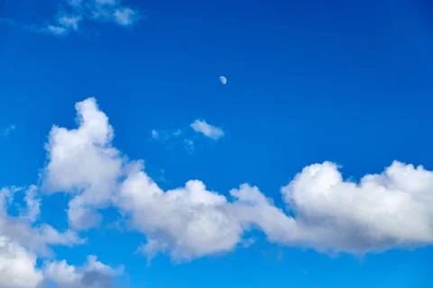 Blue sky background with white clouds and moon Stock Photos