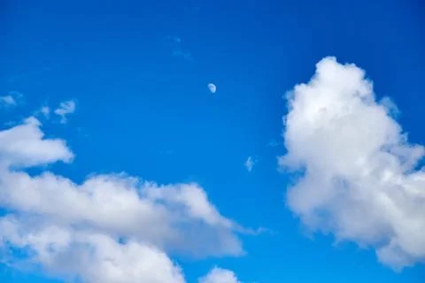 Blue sky background with white clouds and moon Stock Photos