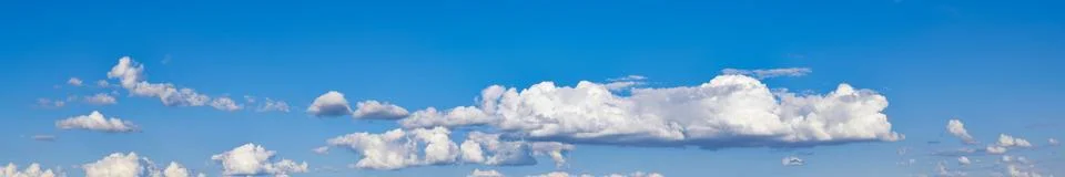 Blue sky background with white clouds. Panoramic widescreen image Stock Photos