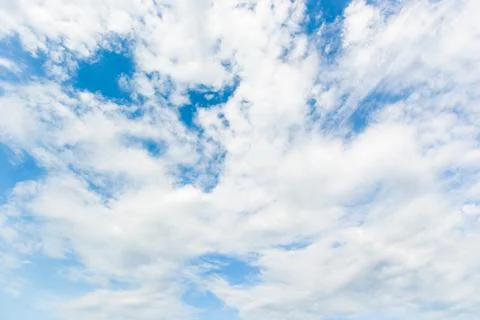 Blue sky background with white clouds cumulus floating soft focus. Stock Photos