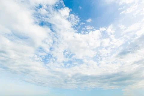 Blue sky background with white clouds cumulus floating soft focus. Stock Photos