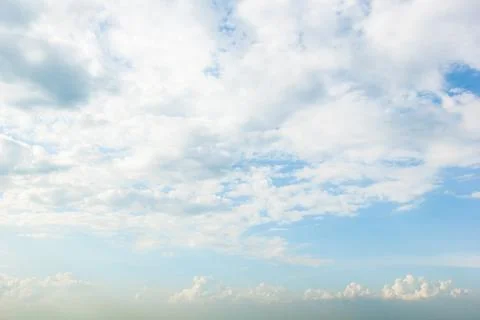 Blue sky background with white clouds cumulus floating soft focus. Stock Photos