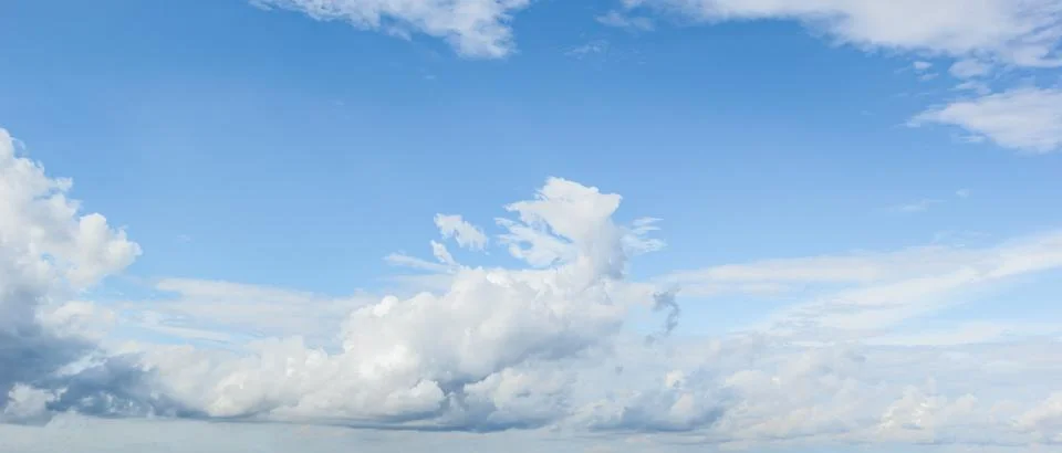 Blue sky background with white clouds cumulus floating soft focus, copy space Stock Photos