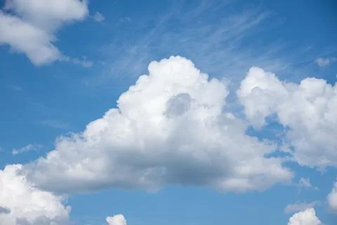 Blue sky background with white fluffy cumulus clouds. Panorama of white fluff Stock Photos
