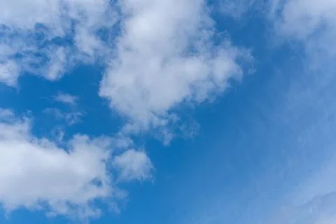 Blue sky background with white fluffy cumulus clouds. Panorama of white fluff Stock Photos