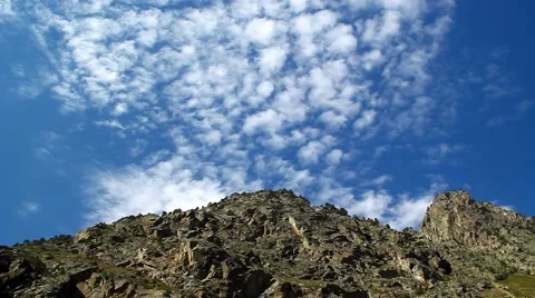 Blue sky with beautiful clouds above the rocks in the mountains Stock Footage 42884948