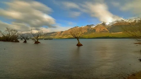 Blue Sky Behind Fast Moving Clouds With Snow Capped Mountain Background At Gl Video stock 106468143