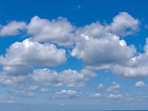 Blue sky between cumulus clouds. Cloudy panoramic background. Scattered clouds Stock Photos